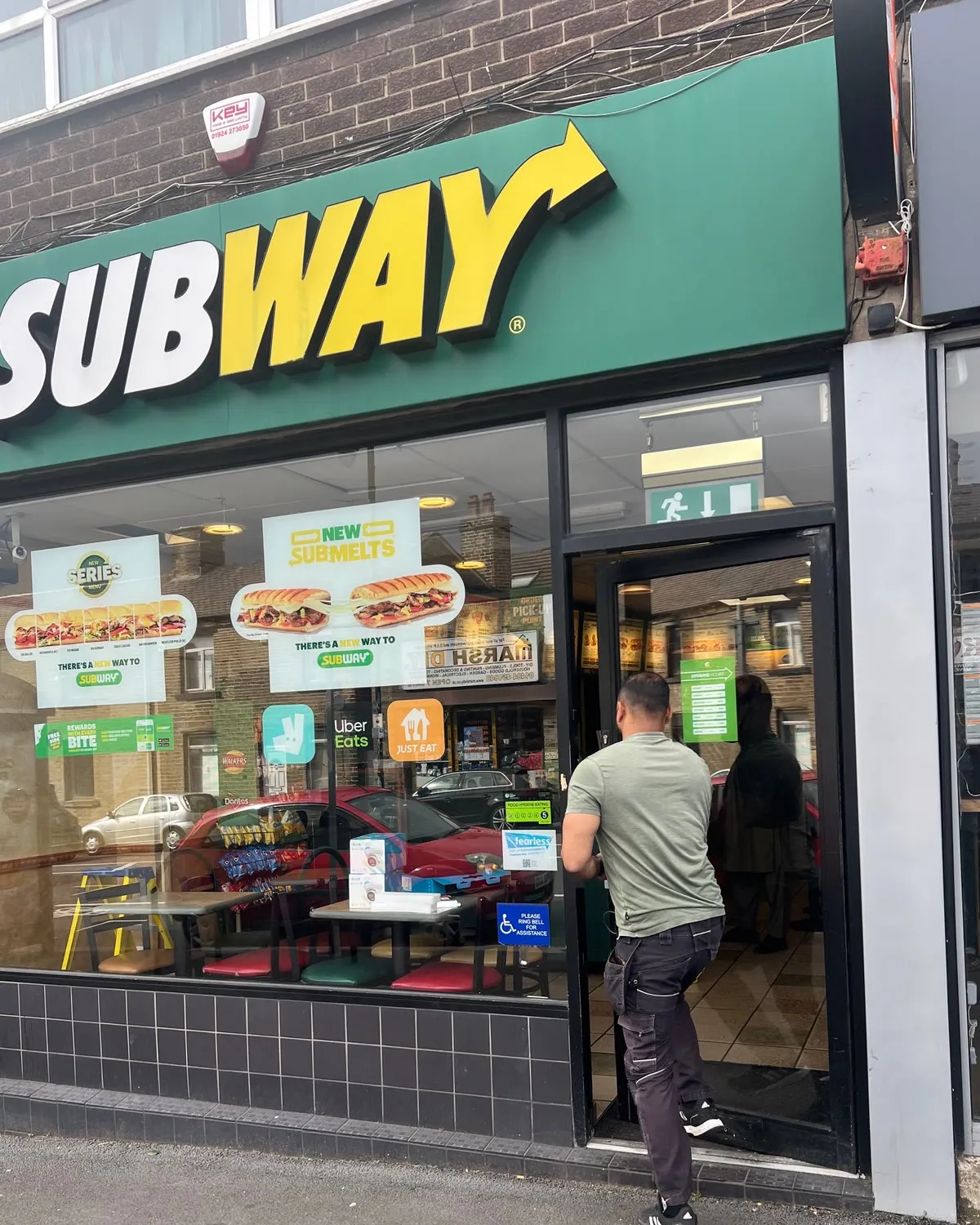The Subway shopfront in Bradford, Mitu walking in through the door with his kit