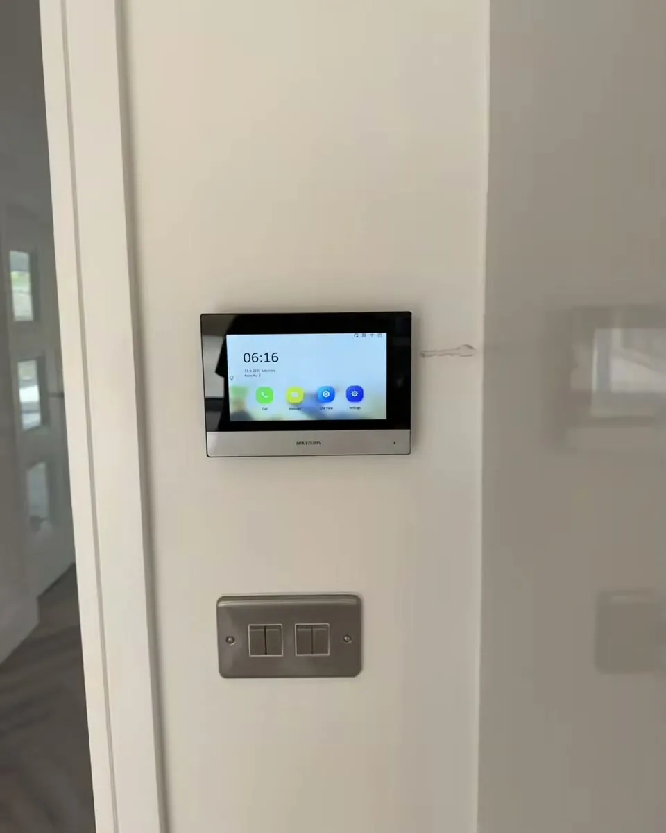 The Hikvision intercom monitor fitted flush to a freshly painted wall inside the house